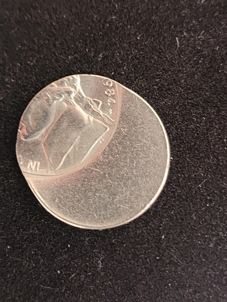 1984 Jefferson nickel off-center strike with design shifted toward one edge and a blank crescent visible on the opposite side